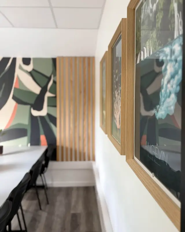 Affiches de paysages de La Réunion dans des cadres en chêne le long de la salle de réunion