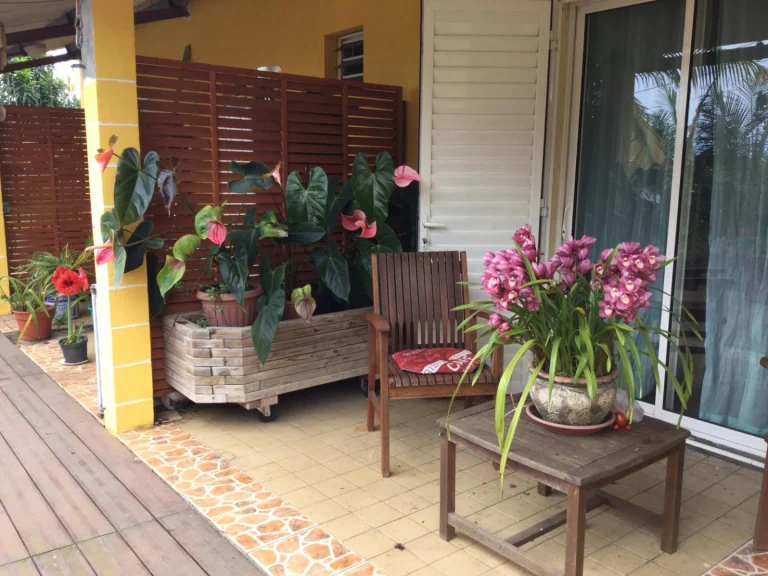 Varangue fleurie d'anthuriums et d'orchidées sur la terrasse bois de Lé Fé Coco, chambres d'hôtes à Saint-Paul